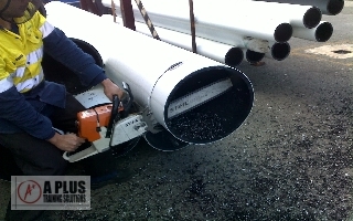 Factory Worker cutting poly with a chainsaw